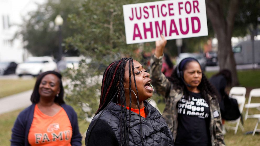 PHOTO: People demanding justice for Ahmaud Arbery stand outside the Glynn County Courthouse, the day after a jury was selected for the trial of three white men charged with killing Black man Ahmaud Arbery, in Brunswick, Ga., Nov. 4, 2021.