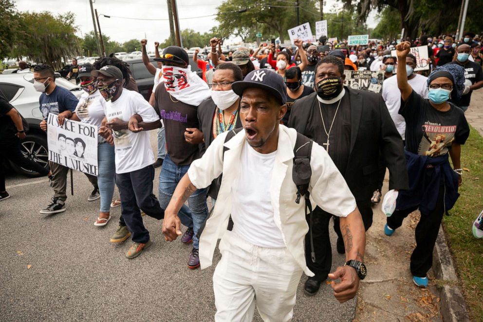 PHOTO: Malik Muhammad, center, joins a group of people marching from the Glynn County Courthouse in downtown to a police station after a rally to protest the shooting of Ahmaud Arbery, Saturday, May 16, 2020, in Brunswick, Ga.