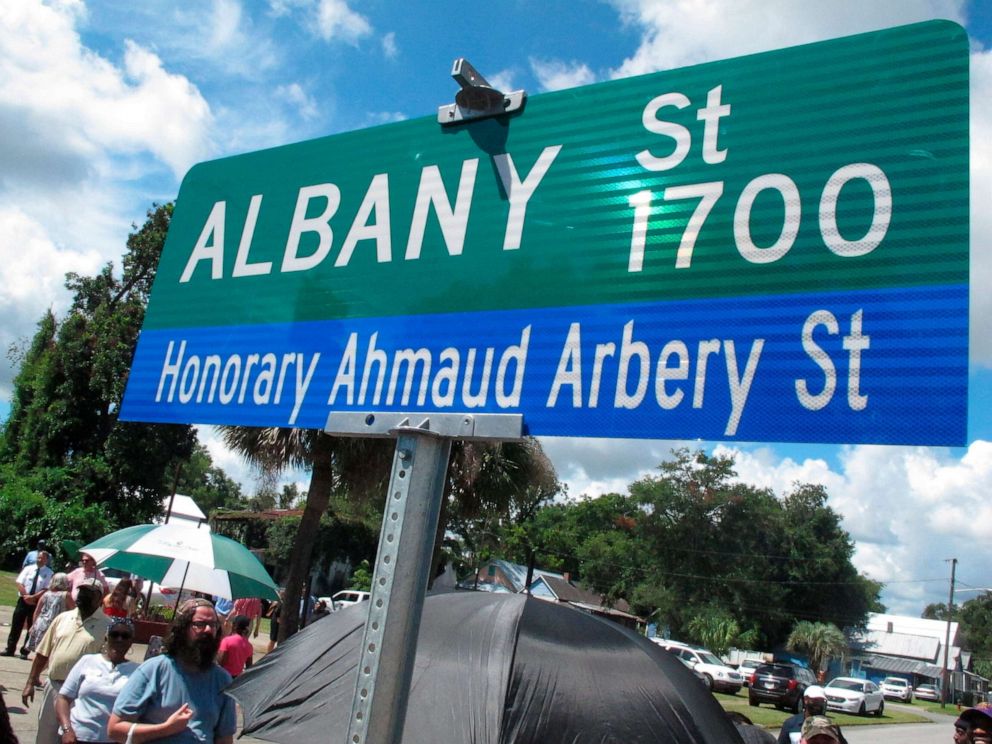 PHOTO: A crowd gathers under a new sign designating a city roadway as Honorary Ahmaud Arbery Street, Aug. 9, 2022, in Brunswick, Ga.