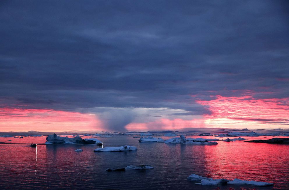 PHOTO: The sun sets as rain falls beyond floating ice and icebergs in Disko Bay above the Arctic Circle on Sept. 4, 2021 in Ilulissat, Greenland. 2021 will mark one of the biggest ice melt years for Greenland in recorded history.