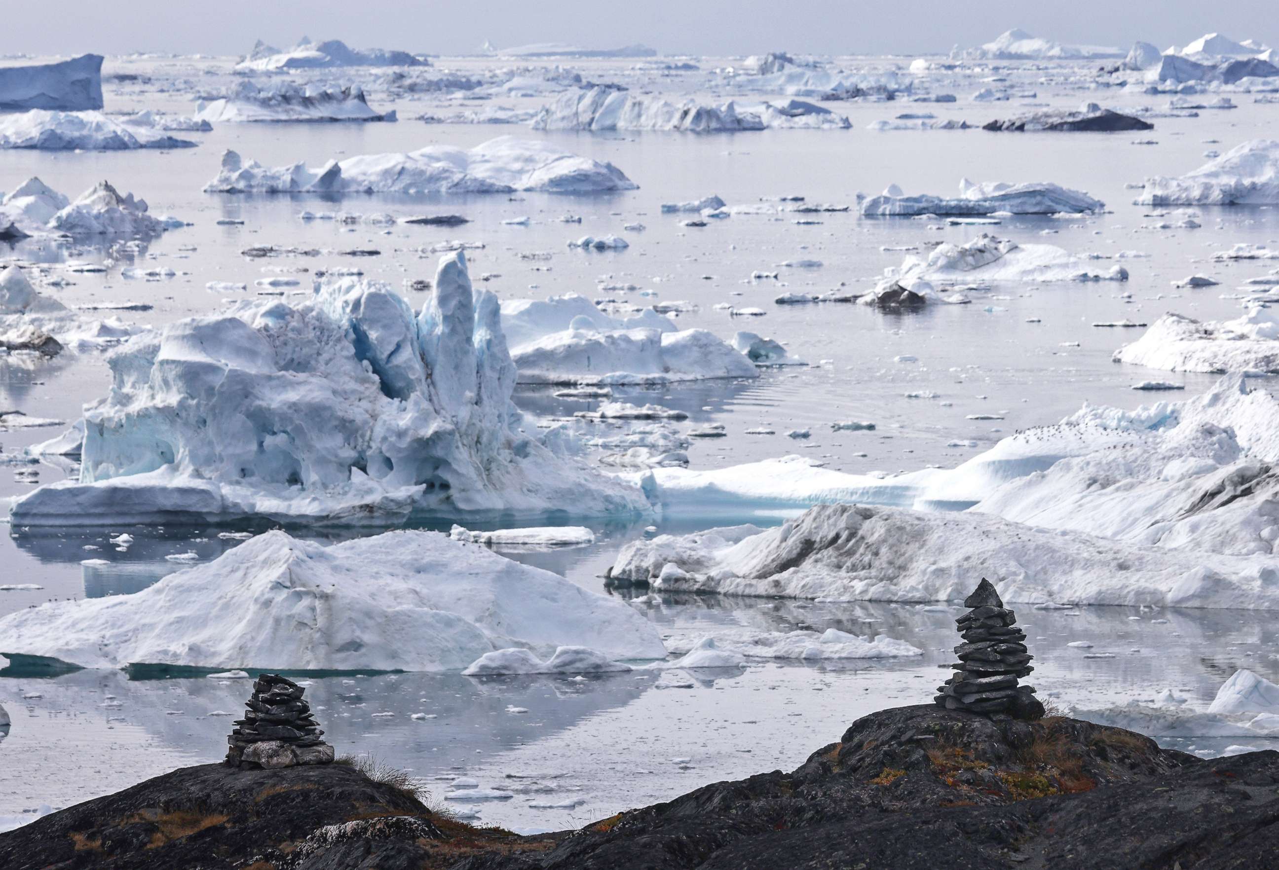 PHOTO: Icebergs float beyond stone mounds known as inuksuks on Sept. 3, 2021 in Ilulissat, Greenland. Inuksuks were traditionally constructed by Arctic peoples for various purposes. 2021 will mark one of the biggest recorded ice melt years for Greenland. 