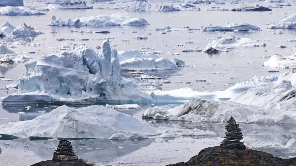 PHOTO: Icebergs float beyond stone mounds known as inuksuks on Sept. 3, 2021 in Ilulissat, Greenland. Inuksuks were traditionally constructed by Arctic peoples for various purposes. 2021 will mark one of the biggest recorded ice melt years for Greenland. 