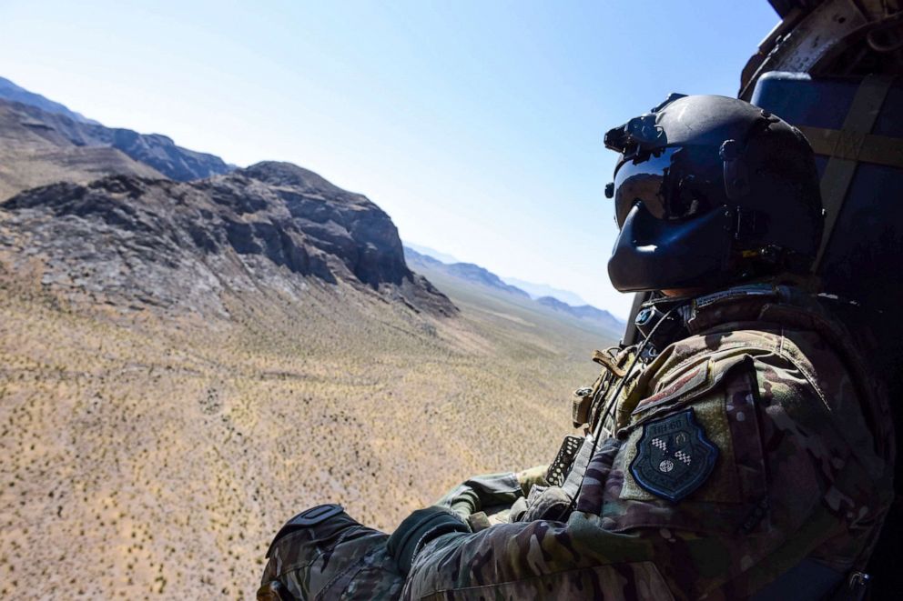 PHOTO: Staff Sgt. Christian Nault, 34th Weapons Squadron special mission aviator, searches the area for the landing zone during a Weapons School Integration mission at the Nevada Test and Training Range June 1, 2017.