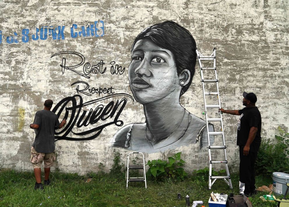 PHOTO: A man paints a mural of Aretha Franklin on a wall down the street where the Rev. Jesse Jackson spoke celebrating the life of singer Aretha Franklin at her father's church, New Bethel Baptist, in Detroit, Aug. 19, 2018.