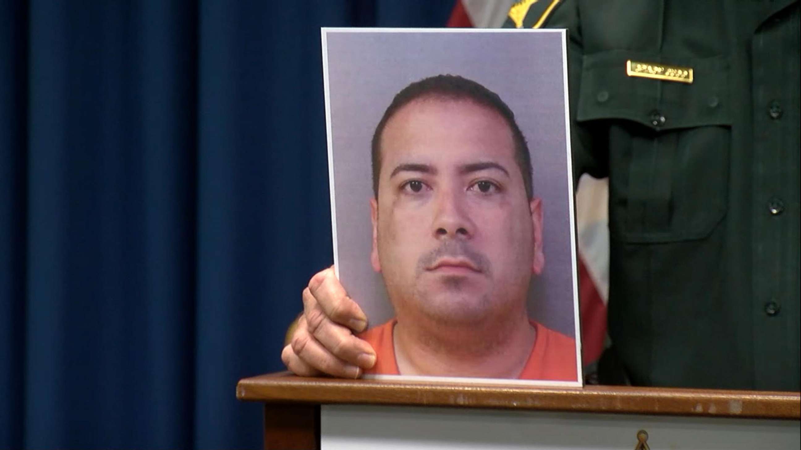 PHOTO: Polk County, Florida, Sheriff Grady Judd holds a photo of  Charles Aguon, the headmaster of a private Christian school, who is suspected of grooming and molesting a 15-year-old student, during a news conference on Feb. 6, 2019.