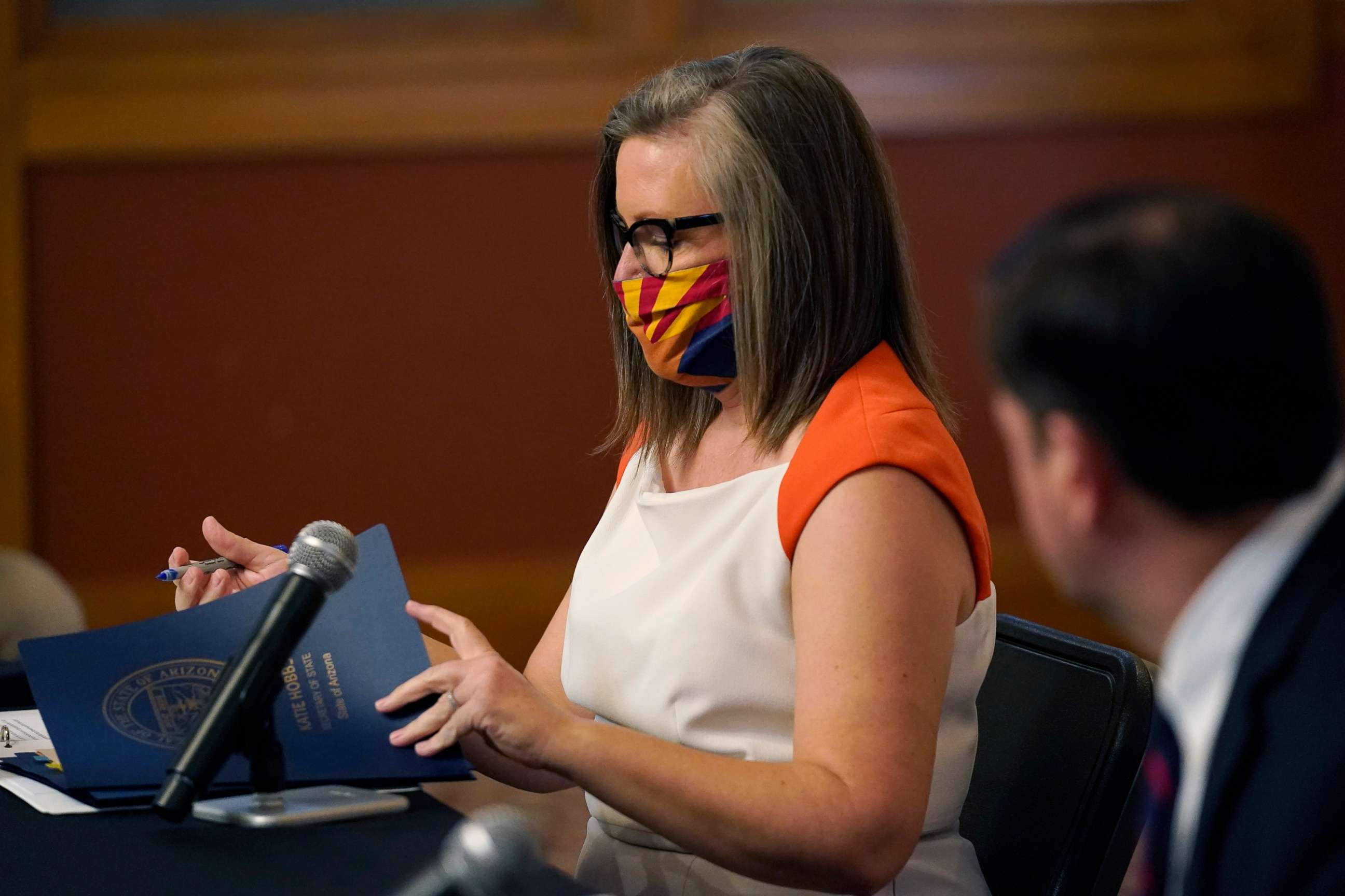 PHOTO: Arizona Secretary of State Katie Hobbs, left, signs documents to certify the election results for federal, statewide, and legislative offices and statewide ballot measures at the official canvass in the Arizona Capitol, Nov. 30, 2020, in Phoenix.