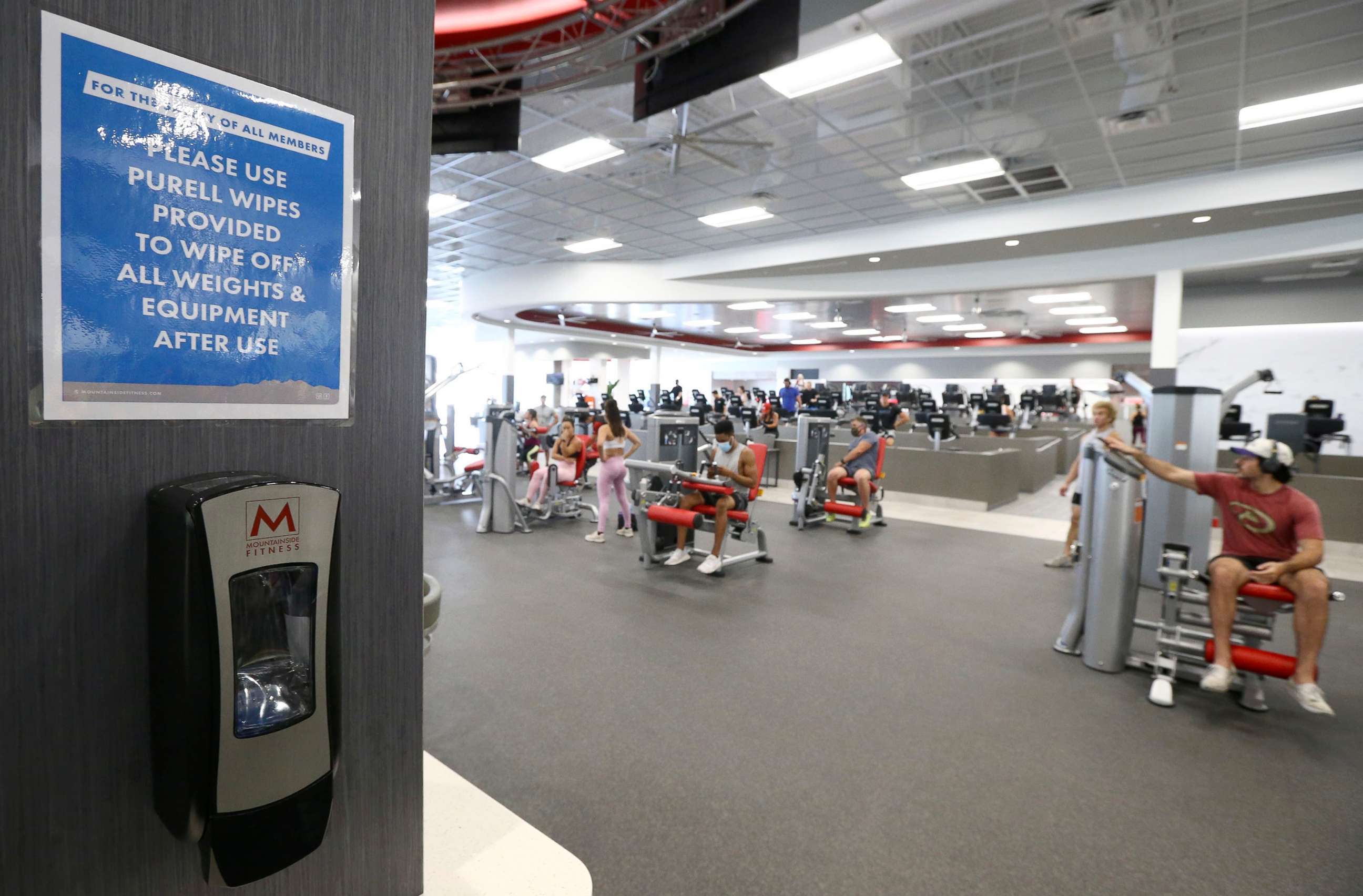 PHOTO: Clients work out at Mountainside Fitness as the facility remains open even as Arizona Gov. Doug Ducey has issued an executive order for all gyms to close due to the surge in coronavirus cases in Arizona, July 2, 2020, in Phoenix.