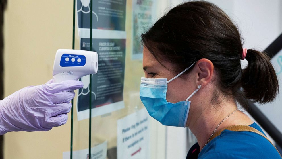 PHOTO: Jillian Golder, an employee of Oro Valley Hospital, has her temperature checked before receiving an antibody test for COVID-19 at the University of Arizona in Tucson, Ariz., July 10, 2020.