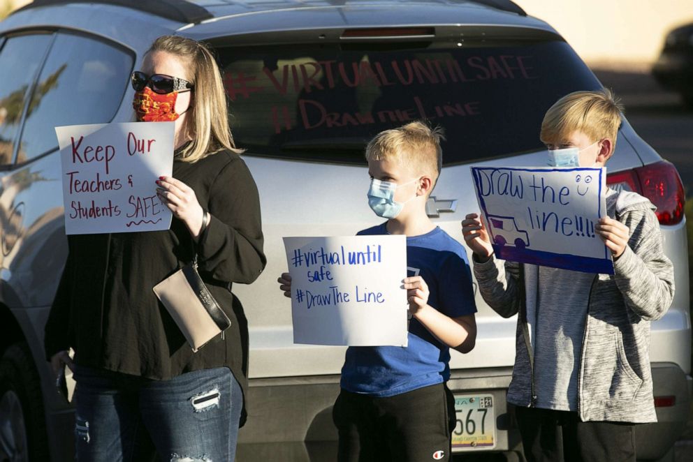 PHOTO: Parents and students protest schools reopening amid the COVID-19 pandemic at the Chandler Unified School District offices on Jan. 4, 2021, in Phoenix.