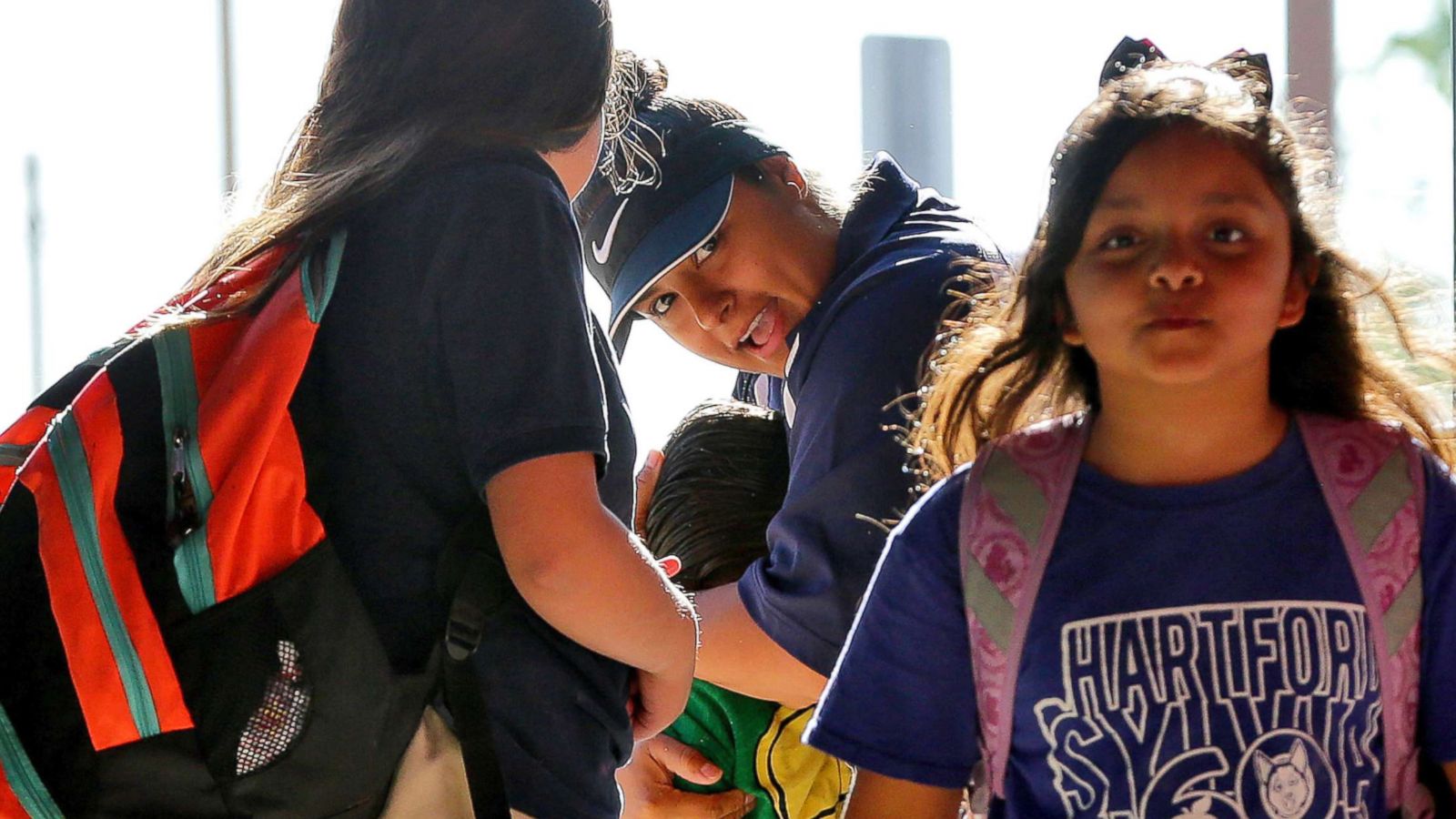 PHOTO: Security guard Jasmine Gutierrez, center, hugs kids as they return to classes at San Marcos Elementary School, May 4, 2018, in Chandler, Ariz., after a statewide teachers strike ended.