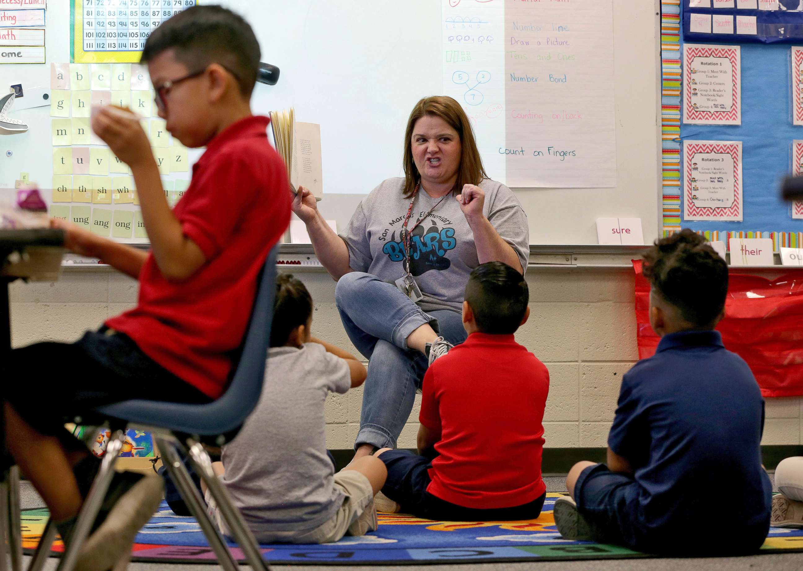 PHOTO: Third grade teacher Jennifer Boettcher reads a story to kids as they eat breakfast at San Marcos Elementary School, May 4, 2018, in Chandler, Ariz., after a statewide teachers strike ended.
