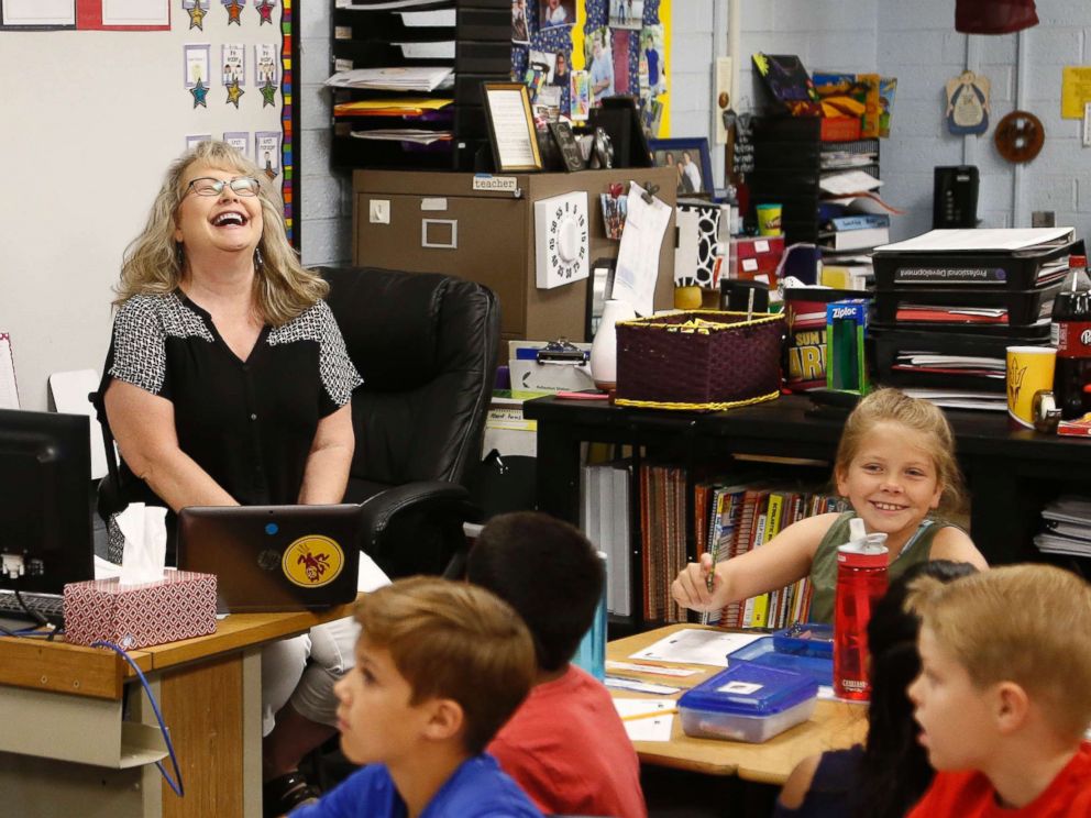 PHOTO: Cindy Cordts, a third grade teacher at Oakwood Elementary School, laughs along with some of her students as schools opened after a statewide teachers strike ended Friday, May 4, 2018, in Peoria, Ariz.