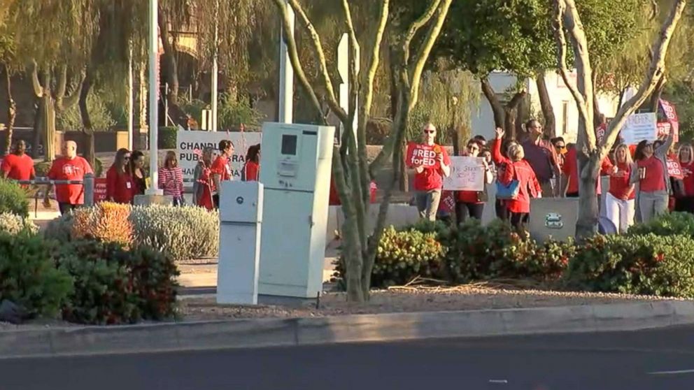 PHOTO: Teachers and supporters in the Phoenix area gathered outside schools to show support for increased teacher pay before the start of classes, April 4, 2018.