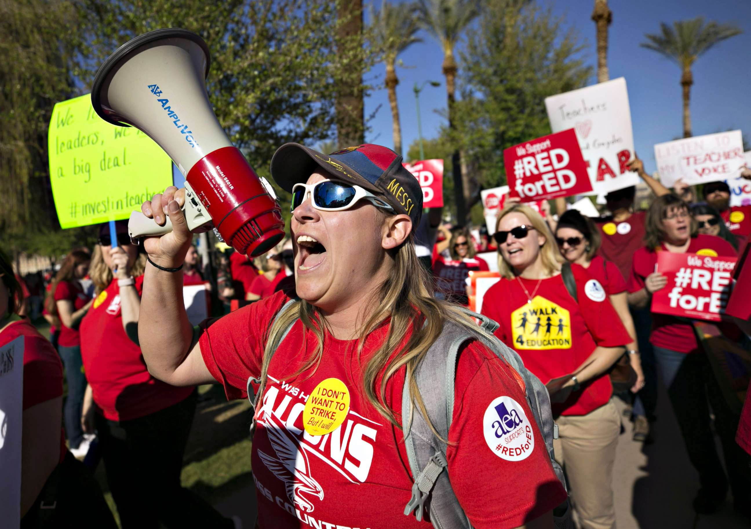 PHOTO: Lindsay Breon, a Physical Education teacher at Washington Elementary School in Phoenix, shouts into a megaphone while  rallying to support teachers during a #RedForEd rally at the Arizona State Capitol, in Phoenix, March 28, 2018.