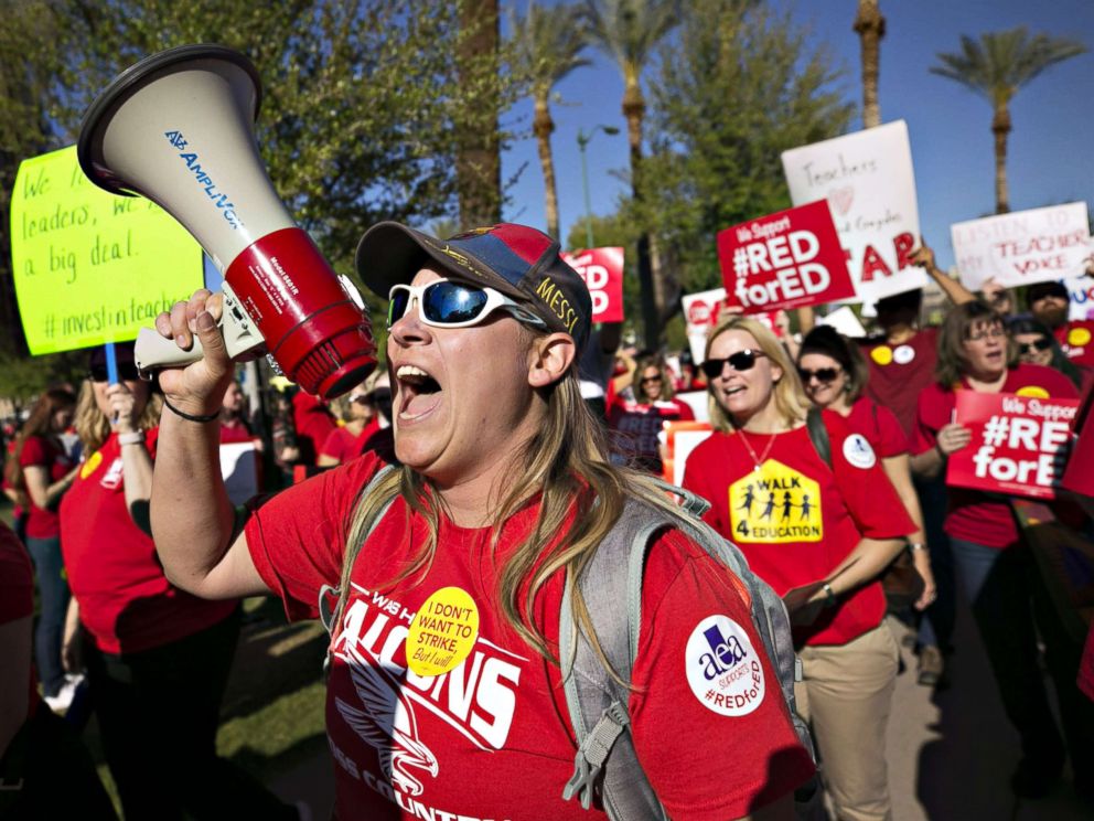 PHOTO: Lindsay Breon, a Physical Education teacher at Washington Elementary School in Phoenix, shouts into a megaphone while rallying to support teachers during a #RedForEd rally at the Arizona State Capitol, in Phoenix, March 28, 2018.