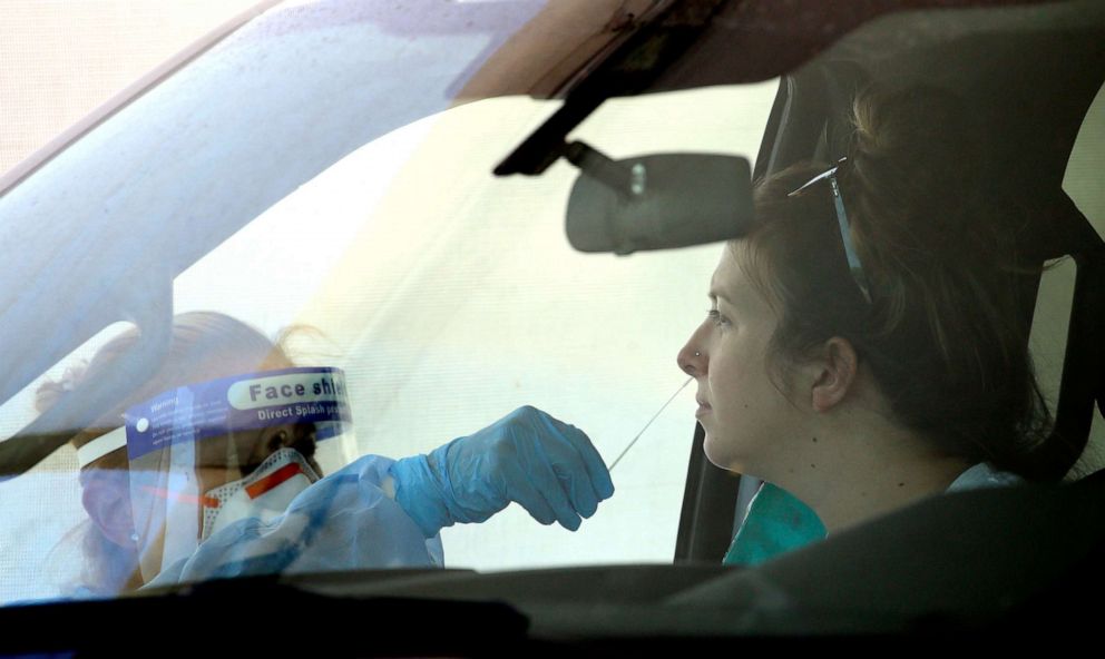 PHOTO: People get tested at a drive thru coronavirus testing site at South Mountain Community College, Thursday, July 9, 2020, in Phoenix.