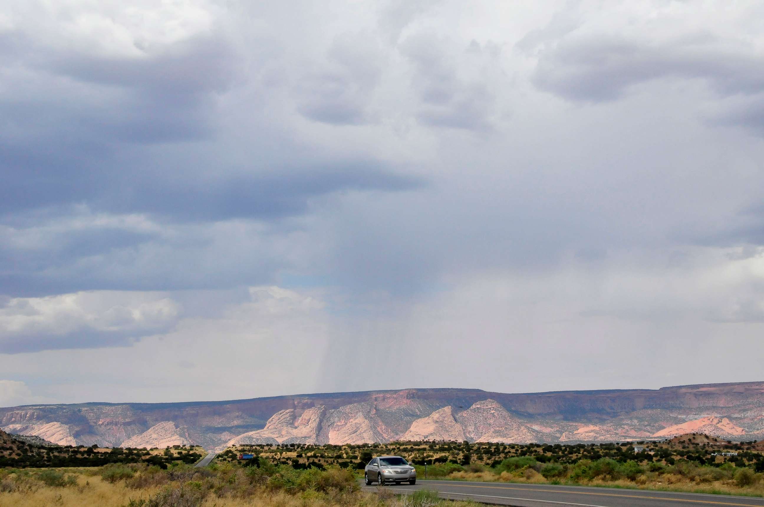 PHOTO: A car drives along Highway 160 near Tuba City, Ariz., Aug. 12, 2012.  
