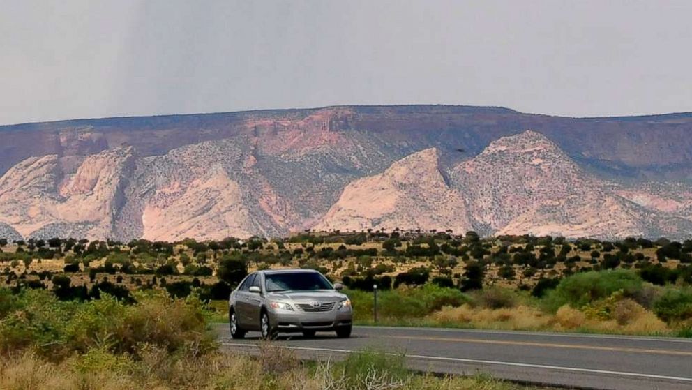 PHOTO: A car drives along Highway 160 near Tuba City, Ariz., Aug. 12, 2012.  