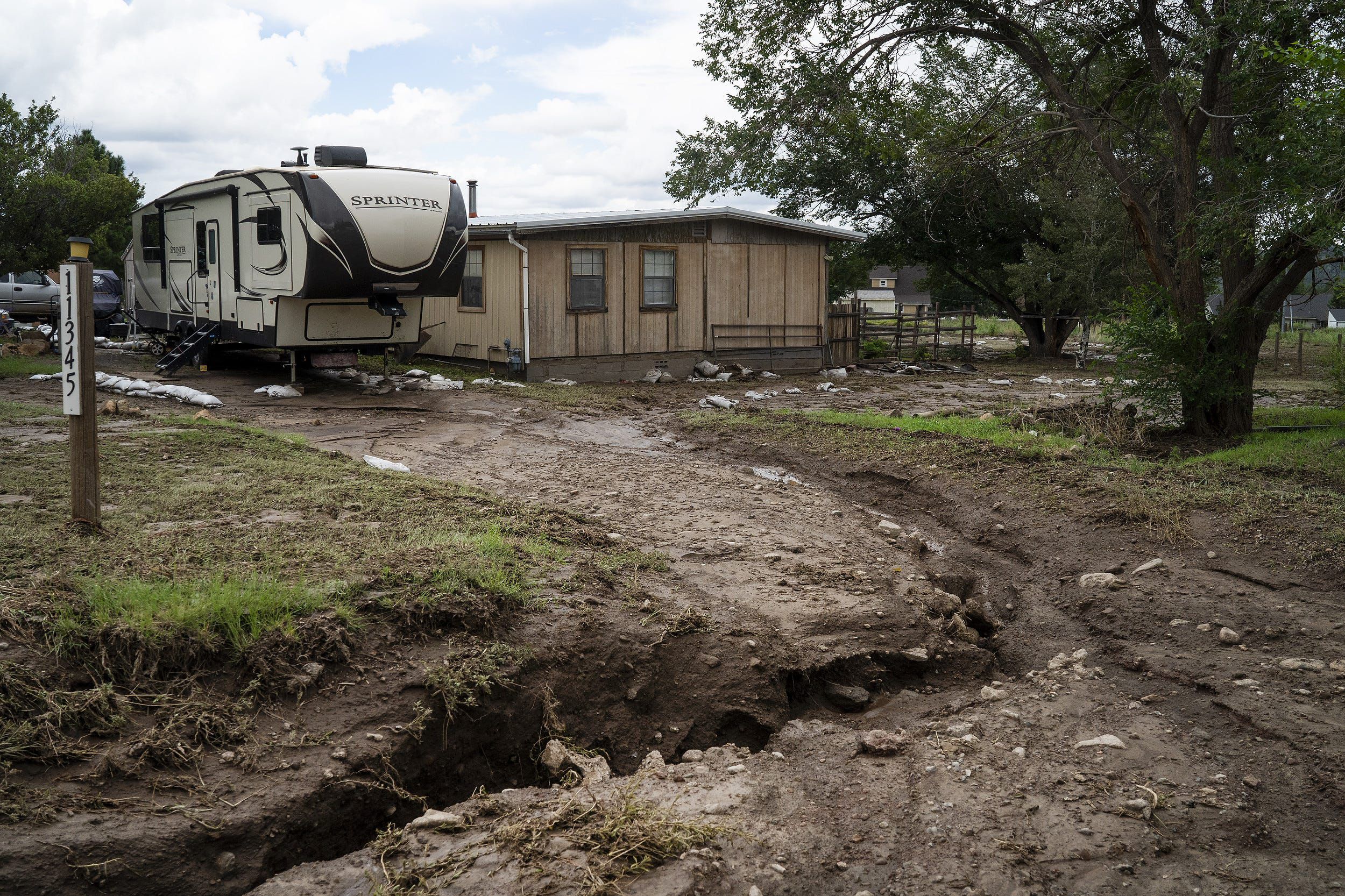 PHOTO: A driveway into a home in the Paintbrush corridor suffers from erosion after persistent flooding, Aug. 19, 2022, in Flagstaff, Ariz.