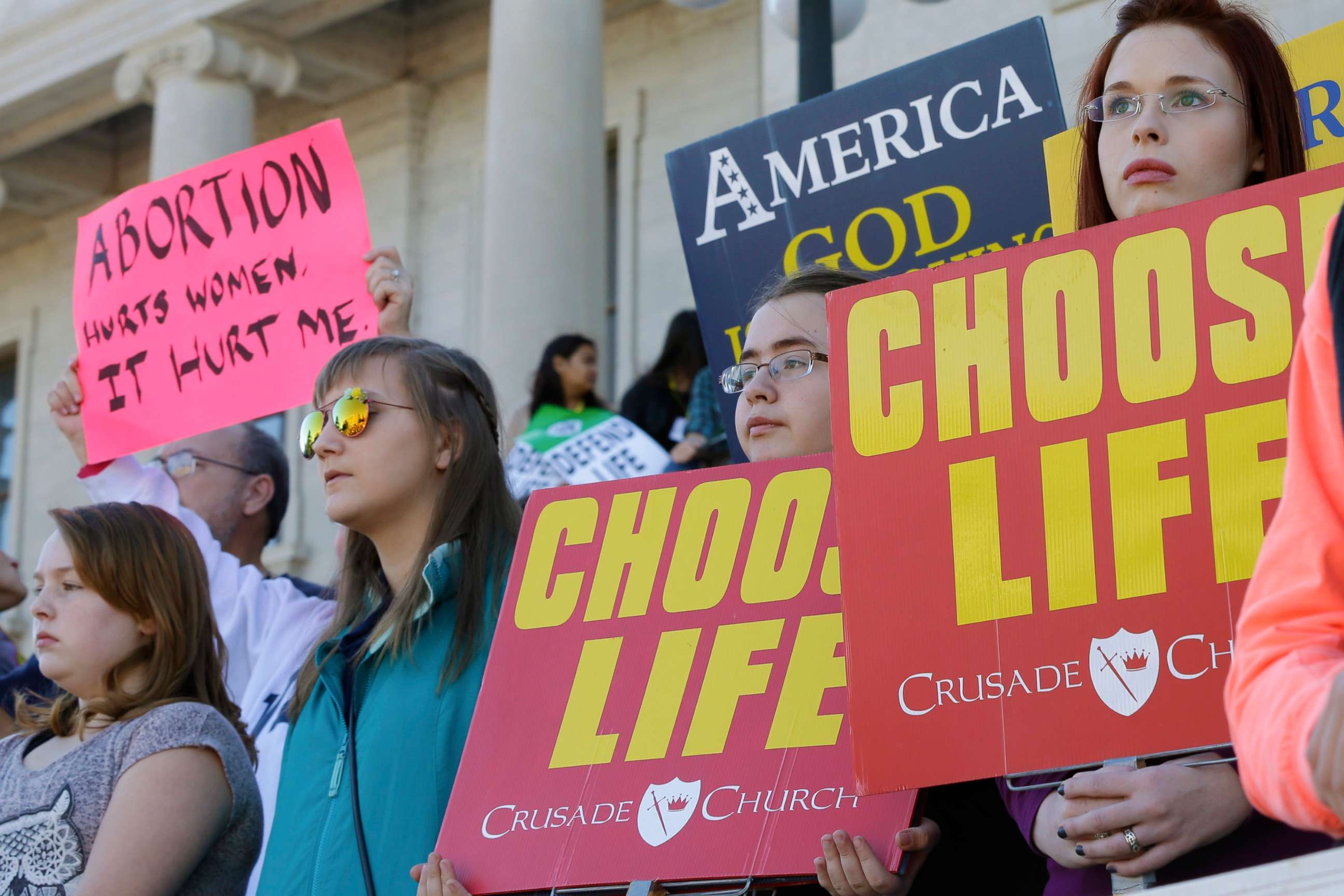 PHOTO: People hold signs as they attend an anti-abortion rally at the Arkansas state Capitol in Little Rock, Ark., Sunday, Jan. 18, 2015.