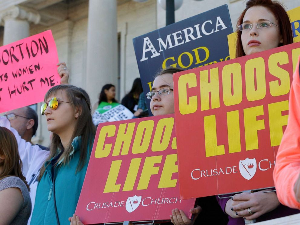 PHOTO: People hold signs as they attend an anti-abortion rally at the Arkansas state Capitol in Little Rock, Ark., Sunday, Jan. 18, 2015.