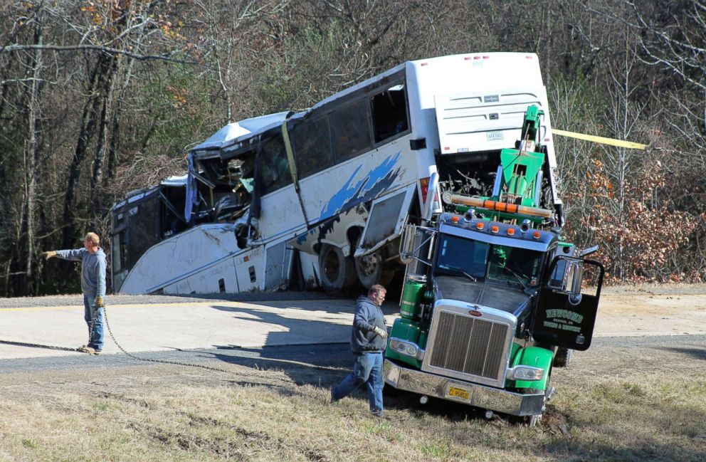 PHOTO: Employees from a wrecker service work to remove a charter bus from a roadside ditc after it crashed alongside Interstate 30 near Benton, Ark., Dec. 3, 2018.