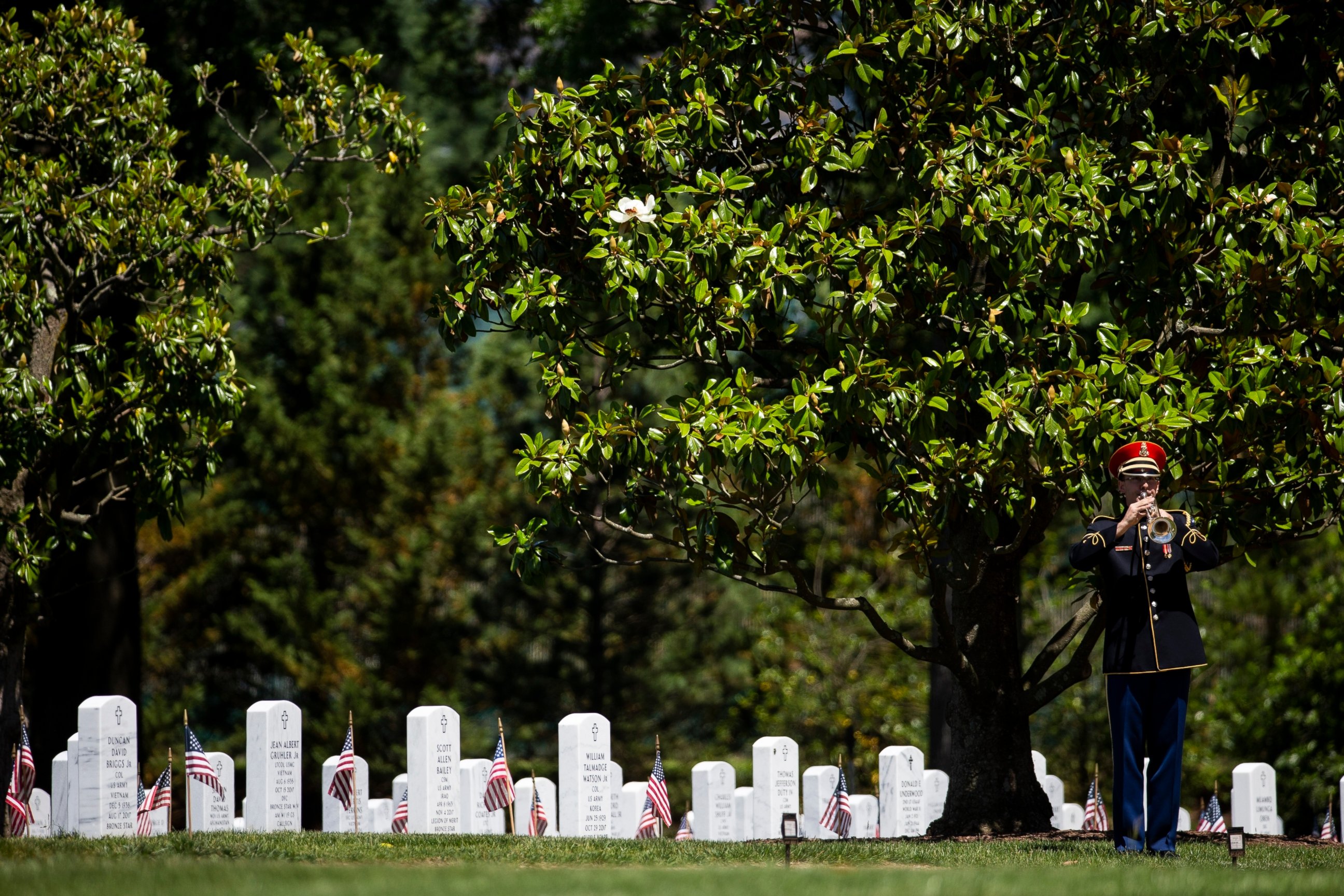 PHOTO: In this May 24, 2019 file photo, a U.S. Army Band bugler plays "Taps," during burial services for a North Carolina National Guard sergeant at Arlington National Cemetery, in Arlington, Va.