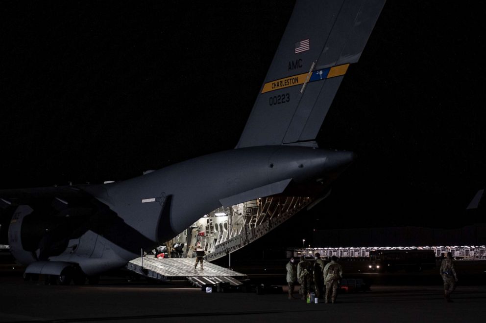 PHOTO: U.S. Air Force Airmen unload medical equipment after transporting COVID-19 patients during the first-ever operational use of the Transport Isolation System at Ramstein Air Base, Germany, April 10, 2020.