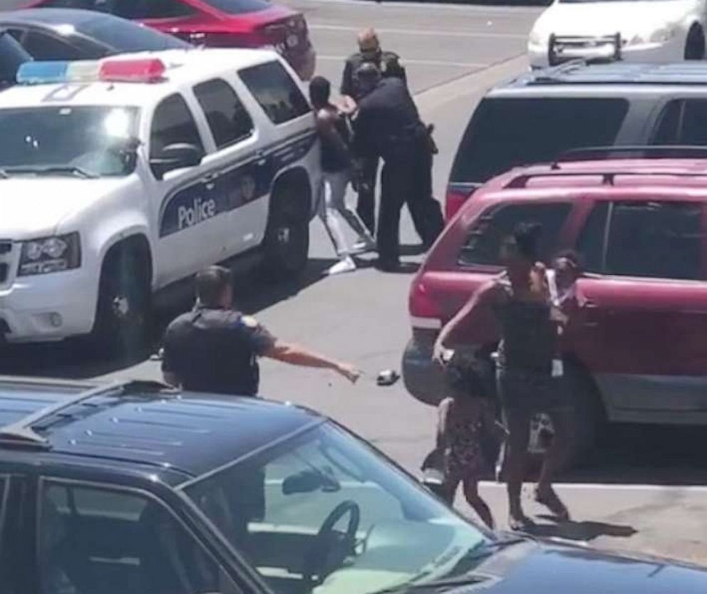 PHOTO: A video on a cell phone shows police officers from the Phoenix Police Department handcuffing Dravon Ames on May 27, 2019.