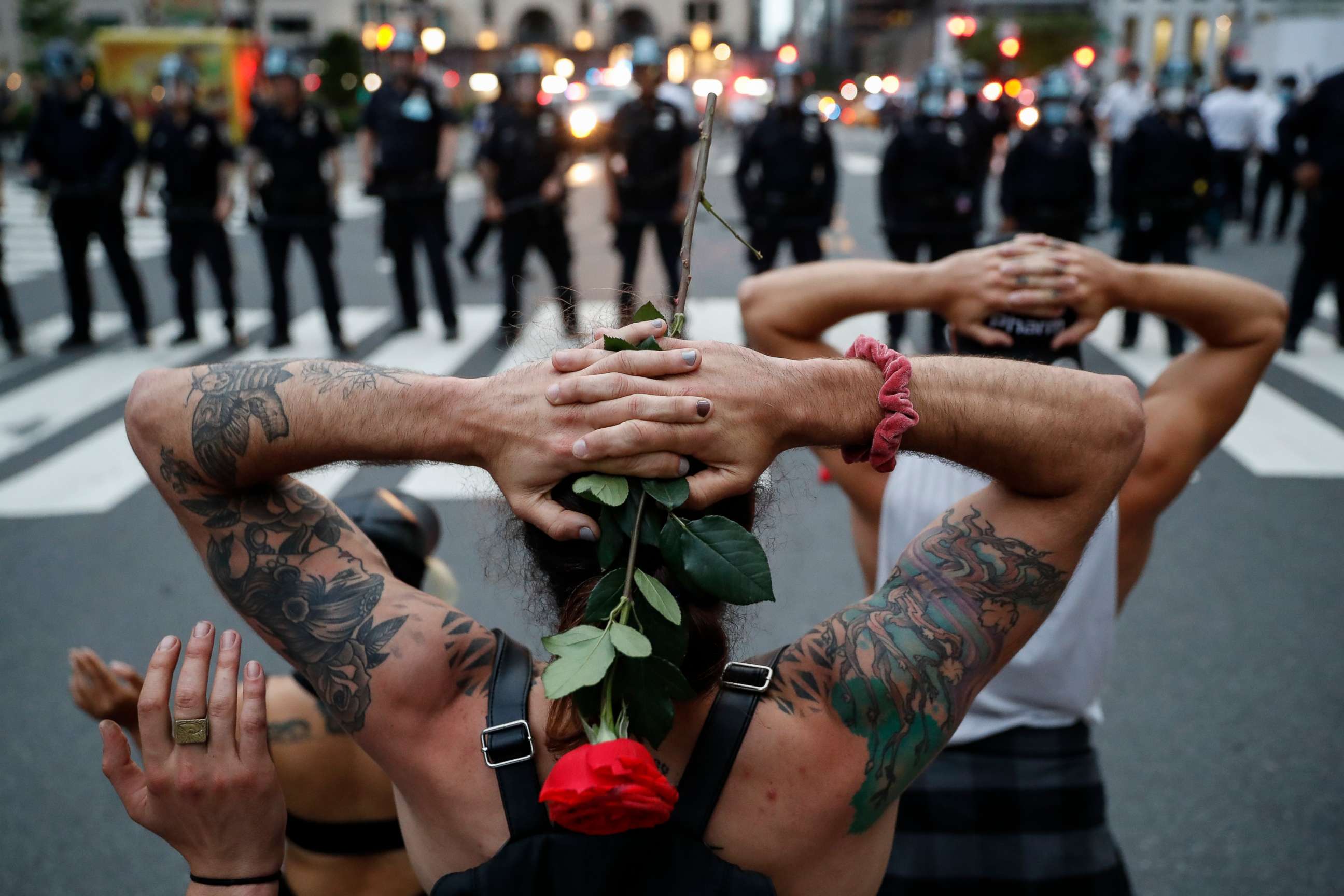PHOTO: Protesters kneel in front of New York City Police Department officers before being arrested for violating curfew beside the iconic Plaza Hotel on 59th Street, June 3, 2020, in New York.