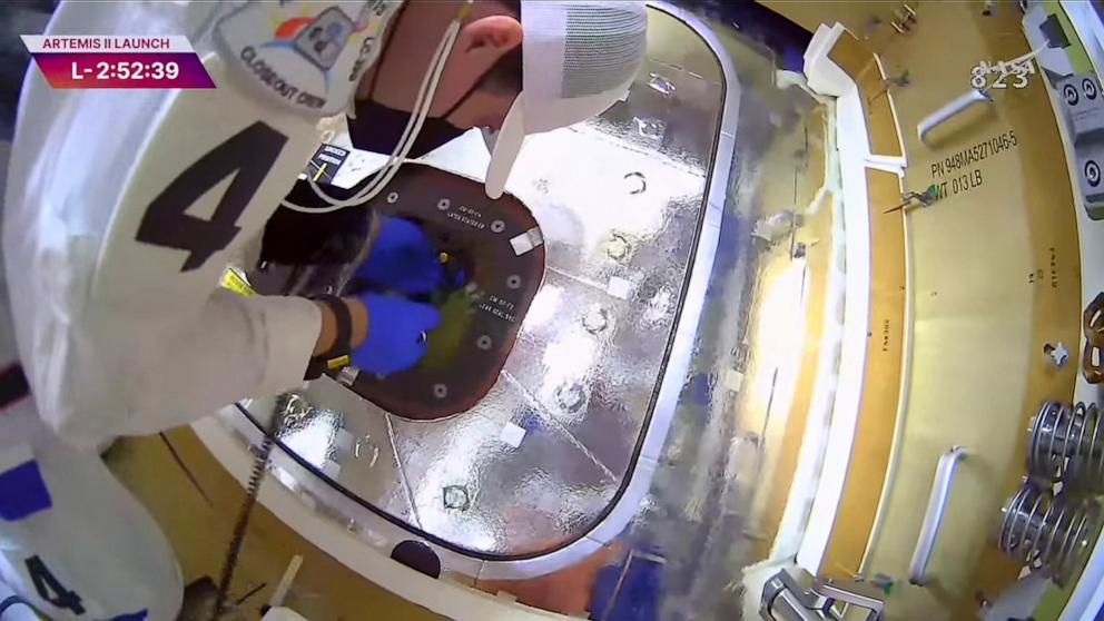 PHOTO: A member of the close out crew closes the hatch on the Orion crew module at the top of the Artemis II rocket at the Kennedy Space Center in Cape Canaveral, Florida, April 1, 2026.