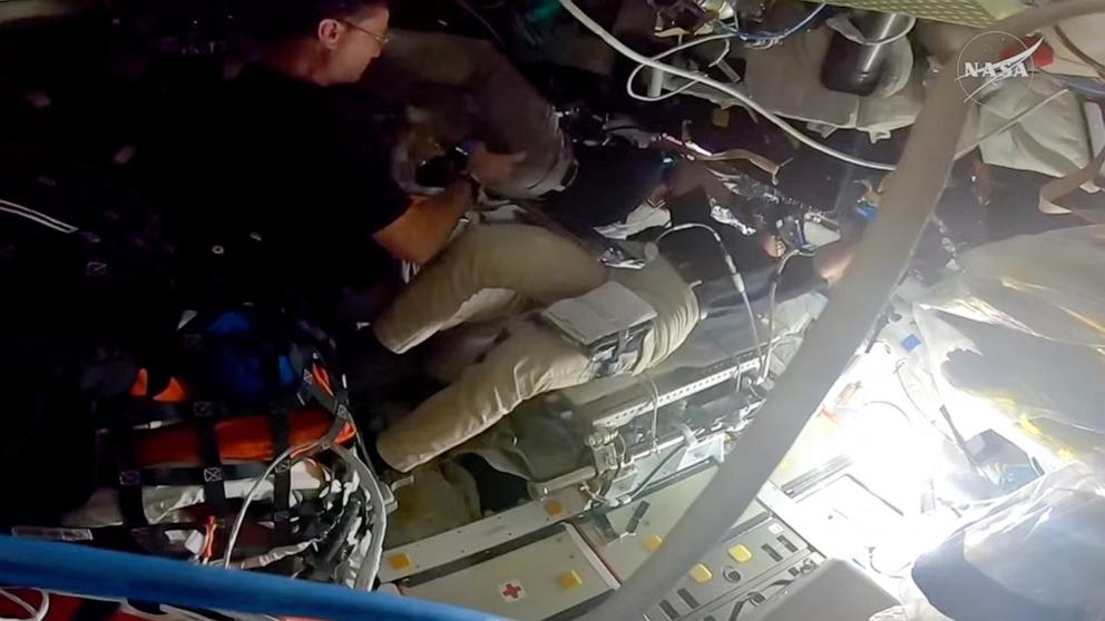 PHOTO: NASA astronaut Christina Koch lays on her back as she take photographs of the Moon out the window of the Orion spacecraft, April 6, 2026.