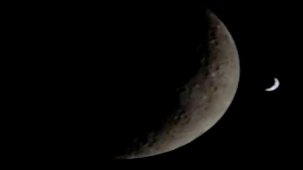 PHOTO: A crescent shaped Earth is seen behind the crescent Moon as seen just before the Orion spacecraft flew on the back side of the Moon, April 6, 2026.