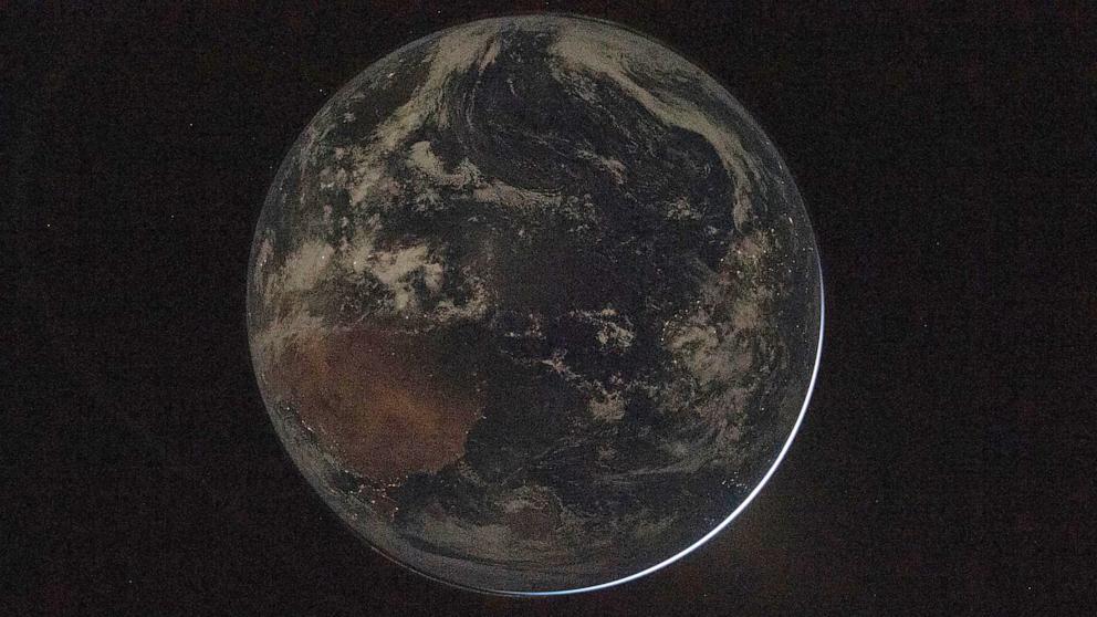 PHOTO: A view of a backlit Earth taken by NASA astronaut and Artemis II Commander Reid Wiseman from one of the Orion spacecraft's window after completing the translunar injection burn on April 2, 2026.