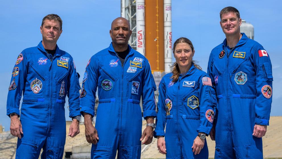 PHOTO: NASA astronauts Reid Wiseman, Victor Glover, Christina Koch and CSA astronaut Jeremy Hansen stop for a group photograph as they visit NASA's Artemis II SLS rocket and Orion spacecraft, March 30, 2026 at the Kennedy Space Center in Florida.