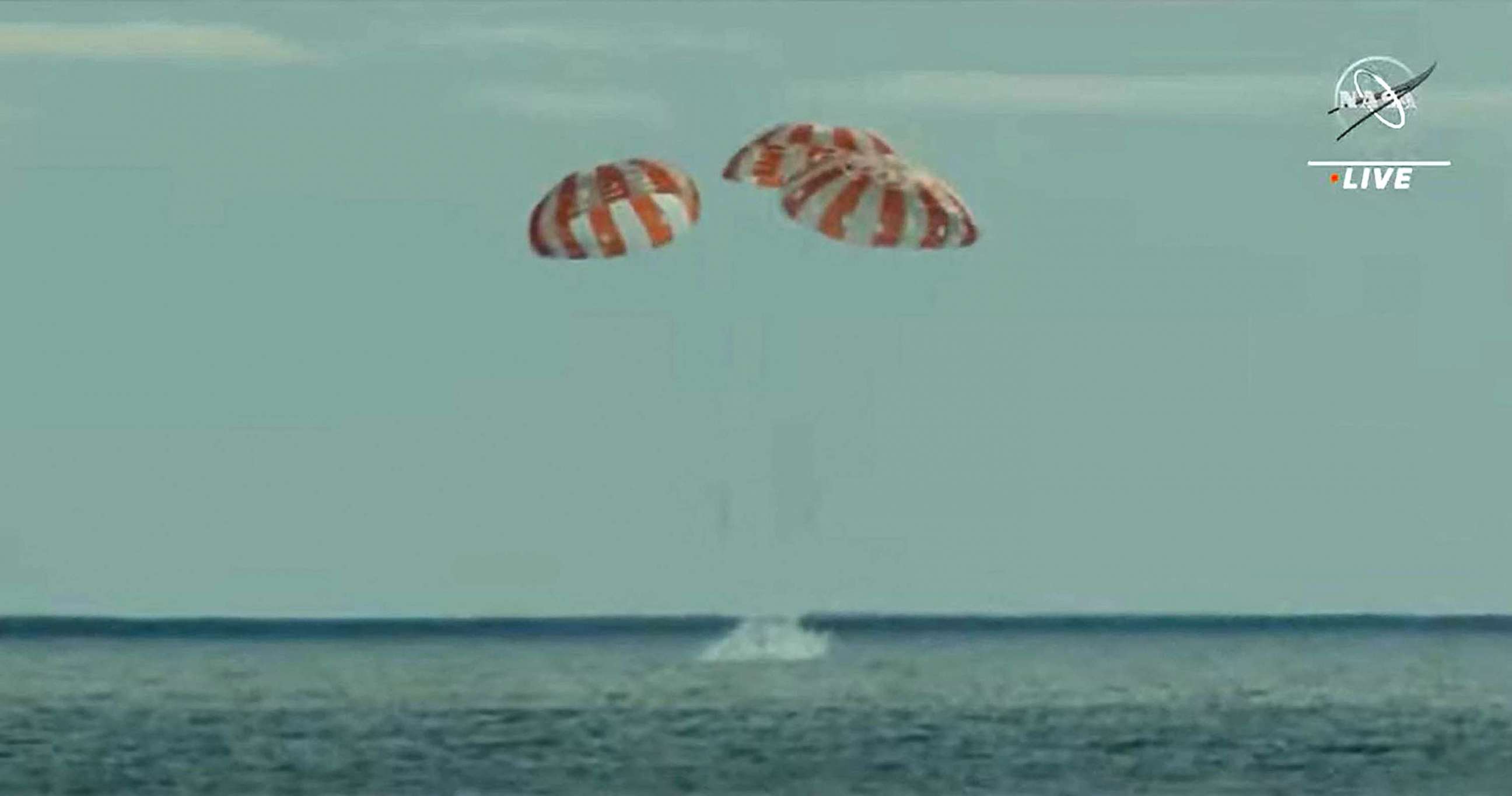 PHOTO: In this still image taken from NASA TV, NASA's unmanned Orion spaceship splashes down in the Pacific Ocean off Baja California, Mexico, Dec. 11, 2022.
