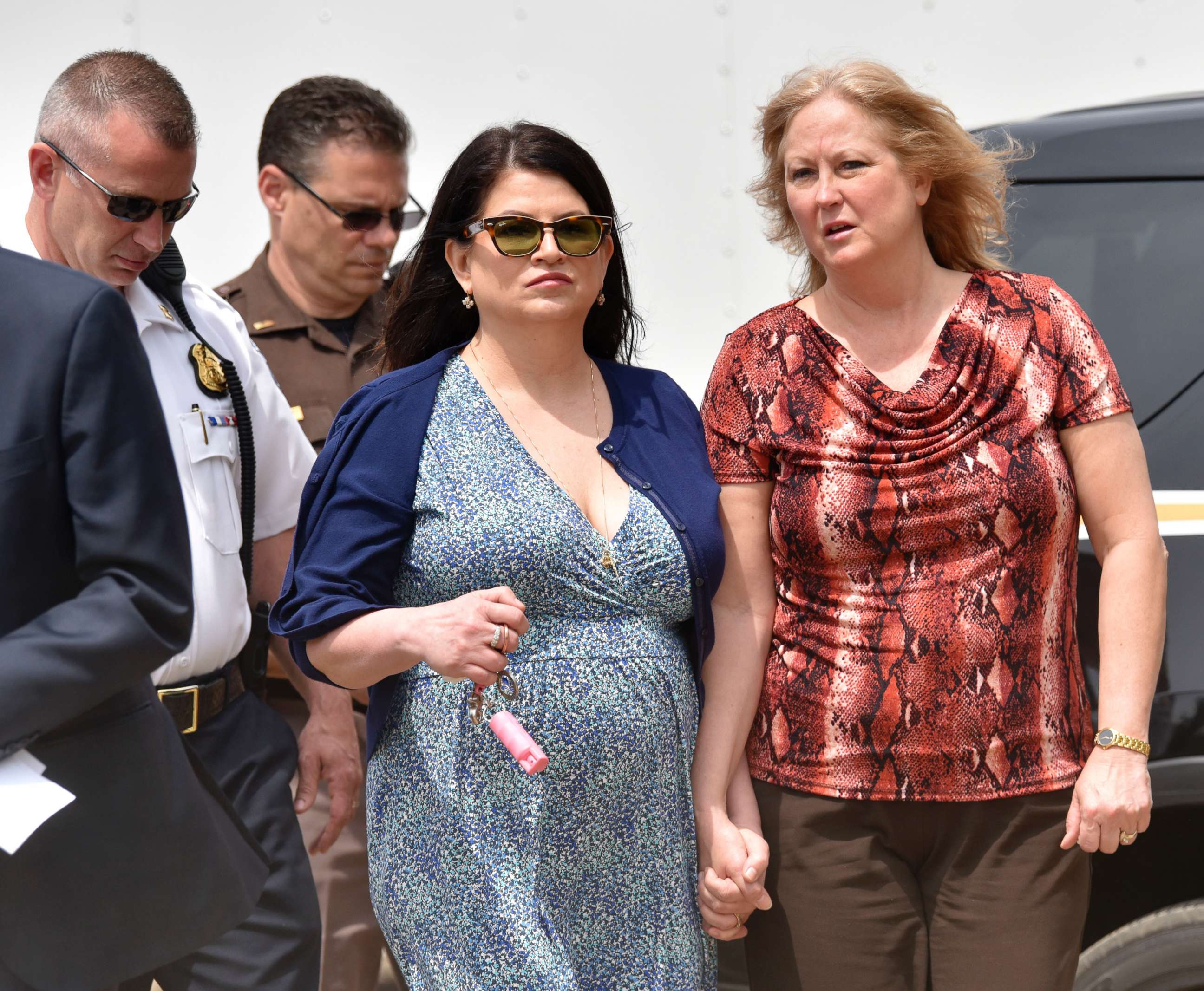 PHOTO: Annie Godbout, in dress, the best friend of Kimberly King and Konnie Beyma, Kimberly's sister, walk to a press conference in Macomb Township, Mich., May 9, 2018. 