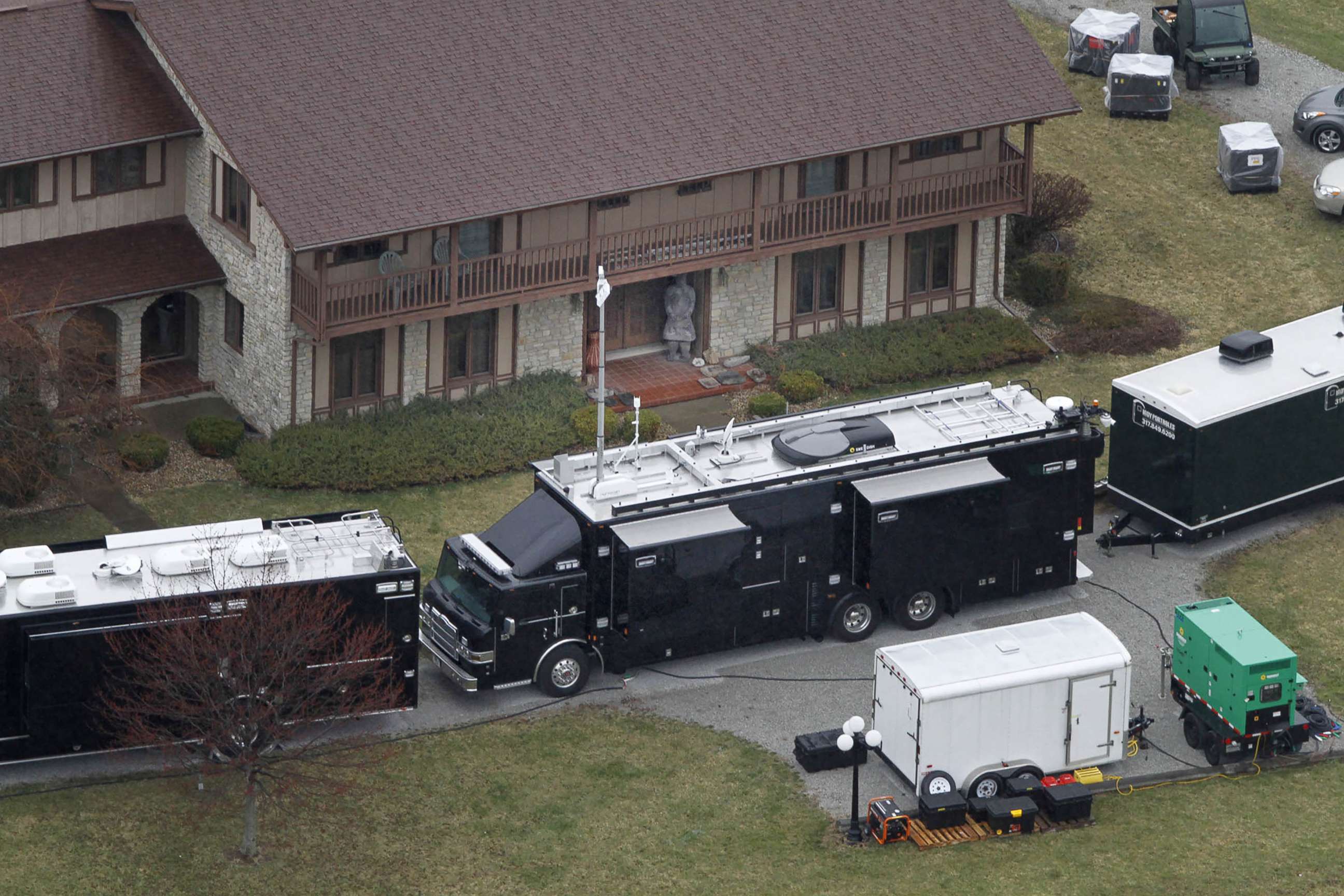 PHOTO: Vehicles are parked outside the home in Waldron, Ind, where FBI agents were at work confiscating artifacts, April 2, 2014.
