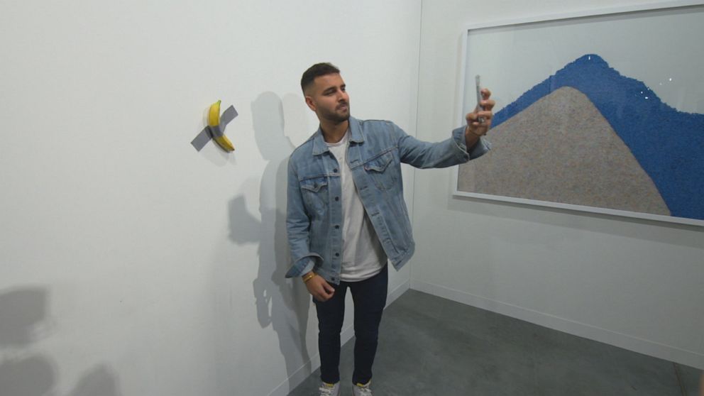 PHOTO: ABC News' Ashan Singh takes a selfie with the $120,000 banana artwork.