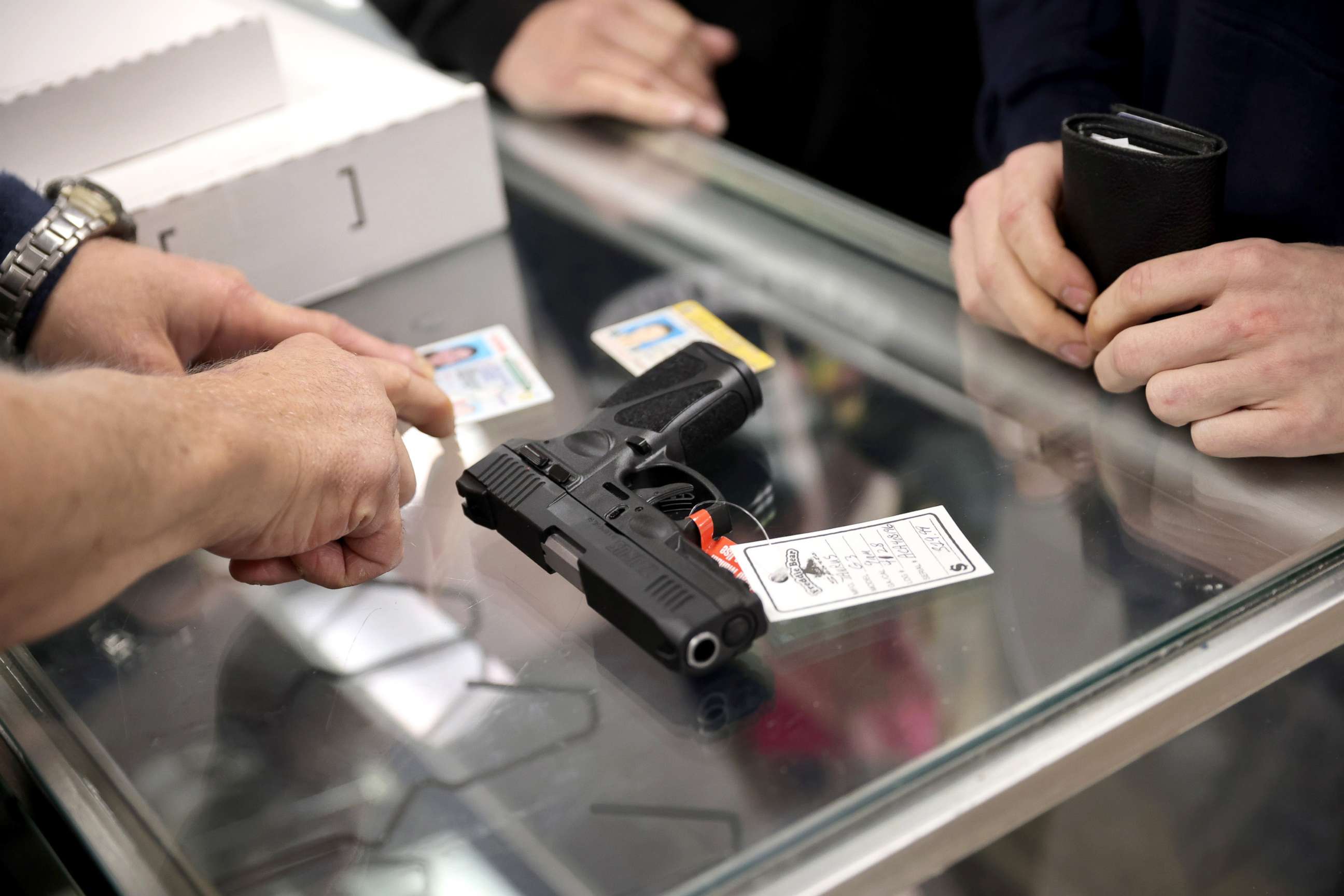 PHOTO: A customer purchases a gun at Freddie Bear Sports on April 8, 2021 in Tinley Park, Ill.