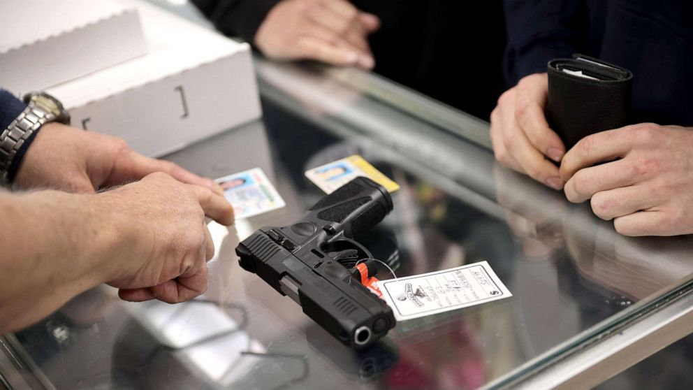 PHOTO: A customer purchases a gun at Freddie Bear Sports on April 8, 2021 in Tinley Park, Ill.