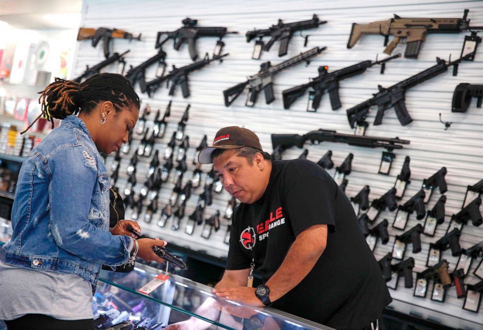 PHOTO: A woman speaks to a salesman about buying a gun before taking her concealed carry certification test at the Eagle Sports gun range in Oak Forest, Ill., July 16, 2017.