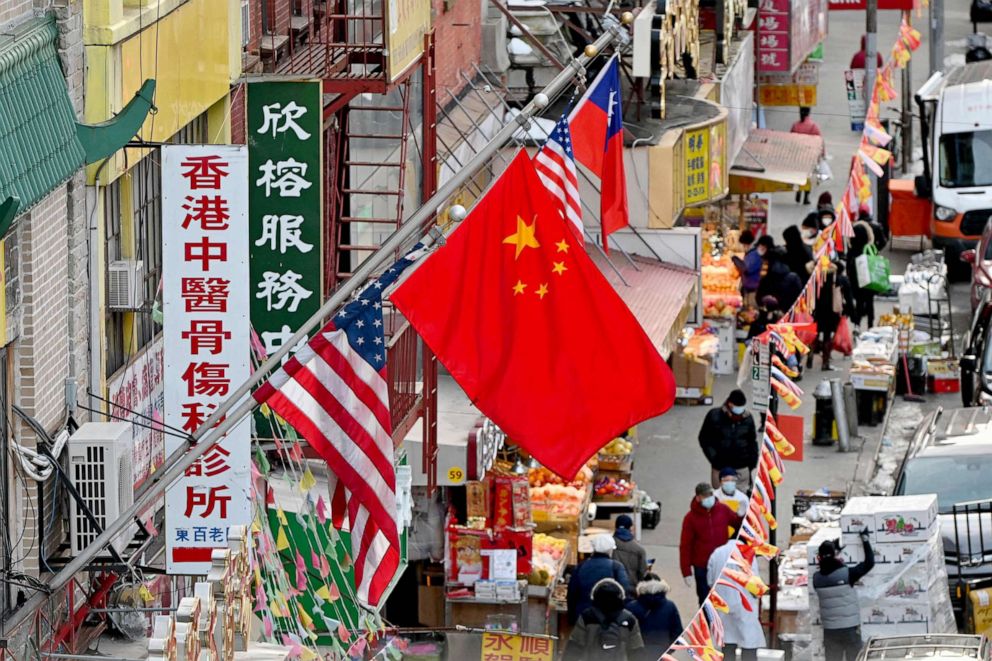 PHOTO: A Chinese flag hangs between American flags in Chinatown in New York, Feb. 17, 2021.