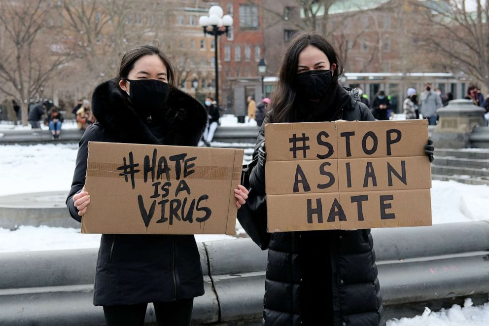 PHOTO: Protestors hold signs that read "hate is a virus" and "stop Asian hate" at the End The Violence Towards Asians rally in Washington Square Park on Feb. 20, 2021, in New York City.