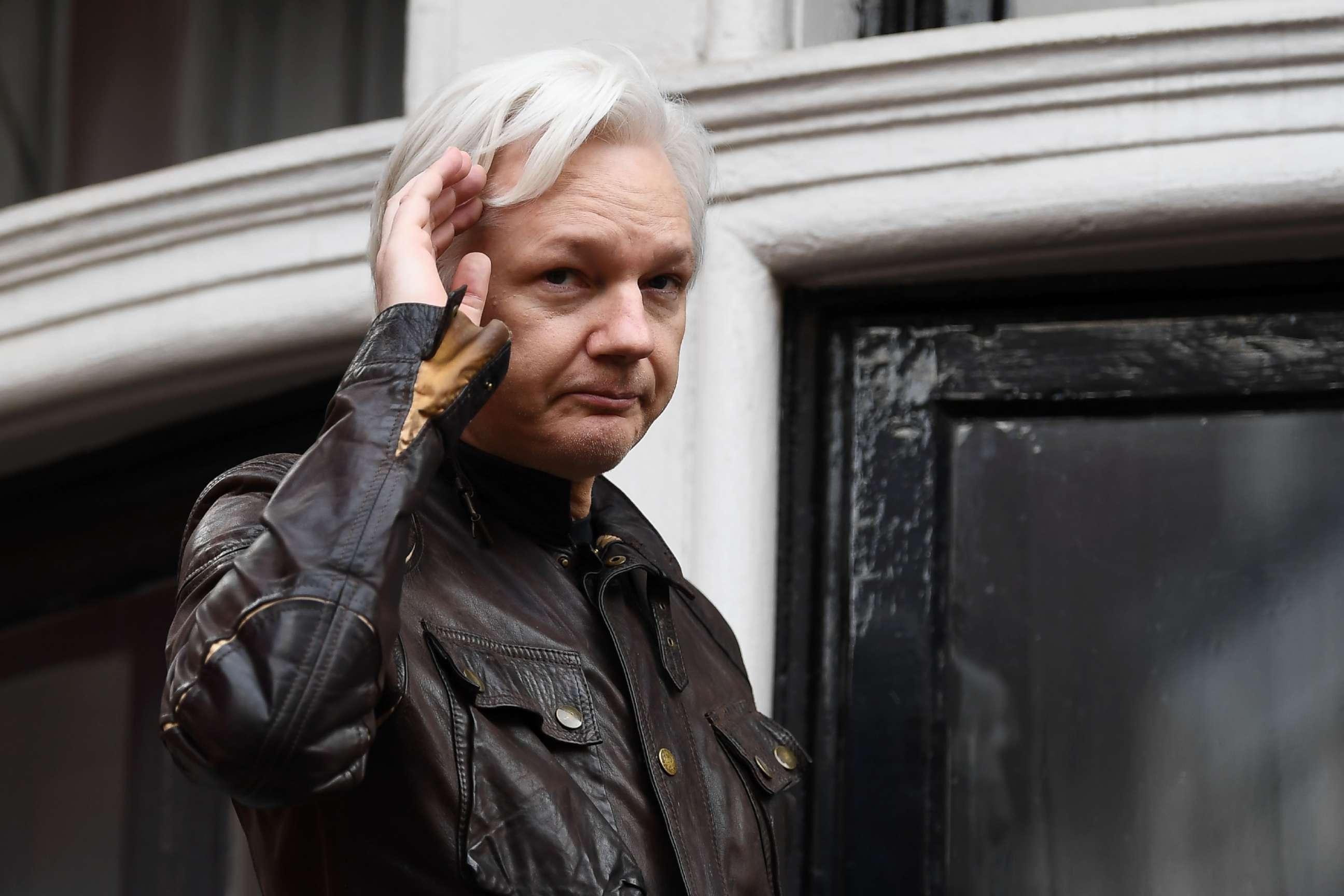 PHOTO: Wikileaks founder Julian Assange appears on the balcony after making an address to the media at the Embassy of Ecuador in London, May 19, 2017.