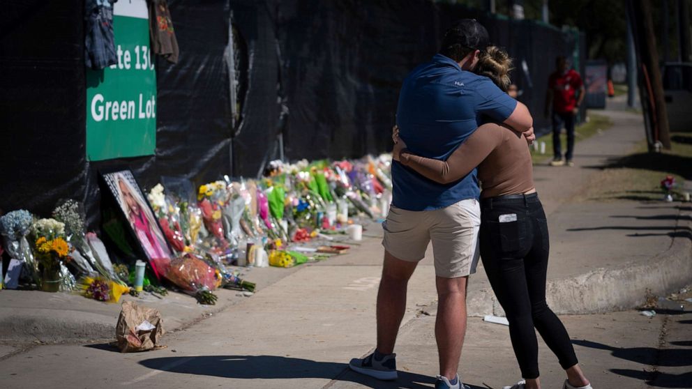 PHOTO: Two people who knew an unidentified victim of a fatal incident at the Houston Astroworld concert embrace at a memorial, Nov. 7, 2021.