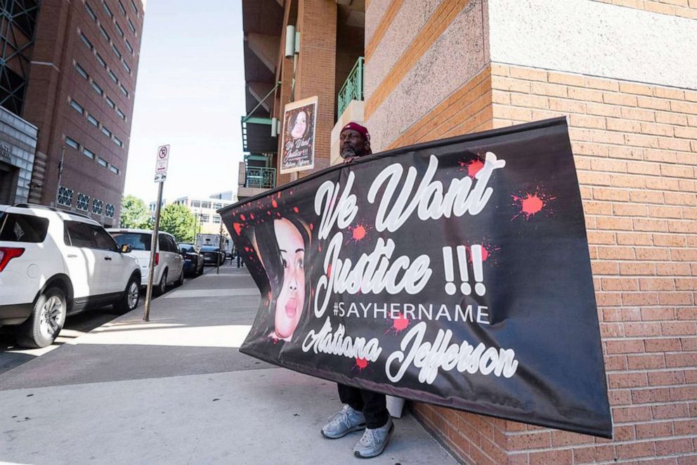 PHOTO: James Smith holds up a sign supporting justice for Atatiana Jefferson as a recusal hearing takes place on Judge David Hagerman's status in the Aaron Dean case, June 23, 2022, in Fort Worth, Texas. 