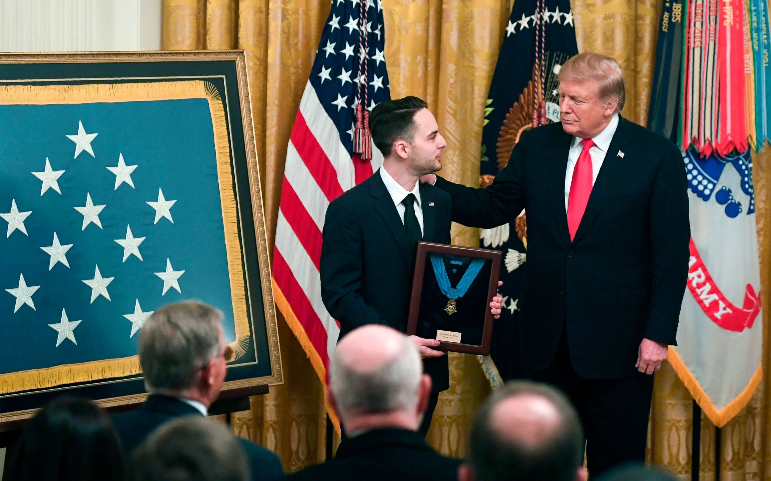 PHOTO: President Donald Trump presents a posthumous Medal of Honor for Army Staff Sergeant Travis Atkins, to his surviving son Trevor Oliver, during a ceremony in the East Room of the White House in Washington, DC, March 27, 2019.
