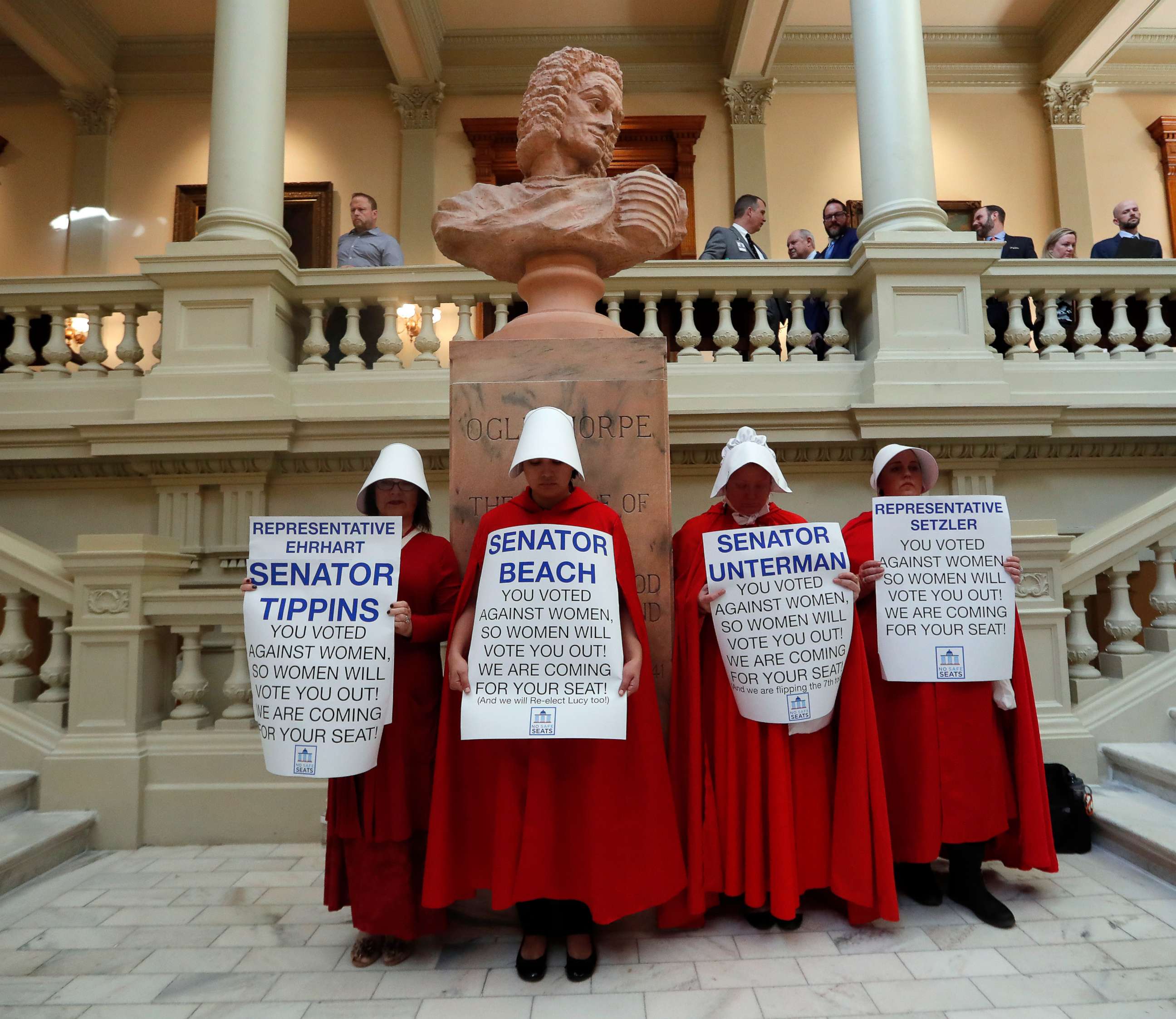 PHOTO: Women hold signs to protest an abortion ban at the state Capitol in Atlanta, April 2, 2019.