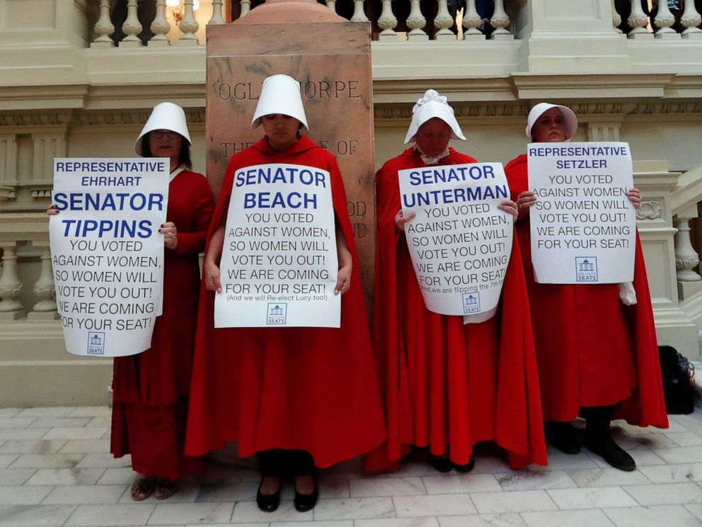 PHOTO: Women hold signs to protest an abortion ban at the state Capitol in Atlanta, April 2, 2019.